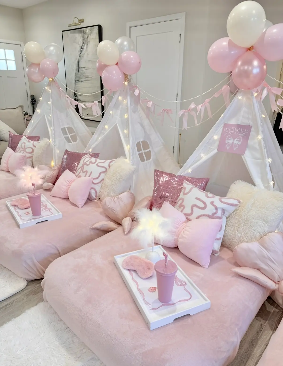 Pink teepee slumber party with fairy lights