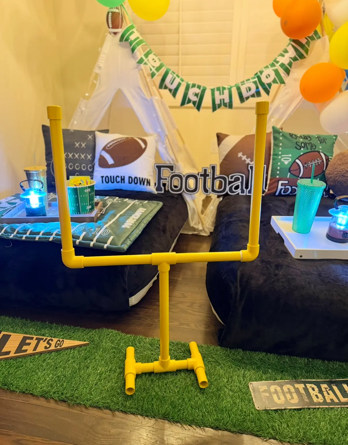 Football-themed indoor sleepover with yellow goalpost