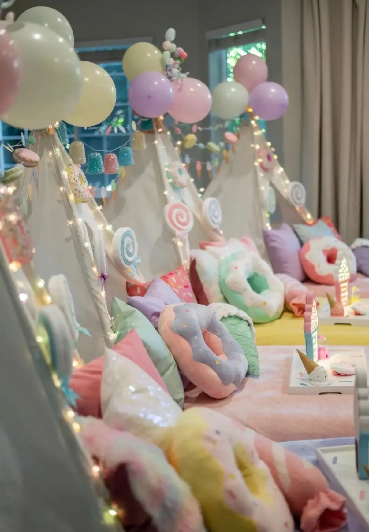 Pastel teepee sleepover with balloons and unicorns