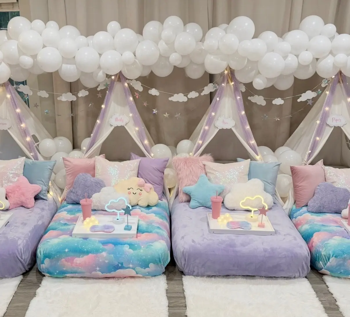 Whimsical pastel sleepover tents under balloon clouds