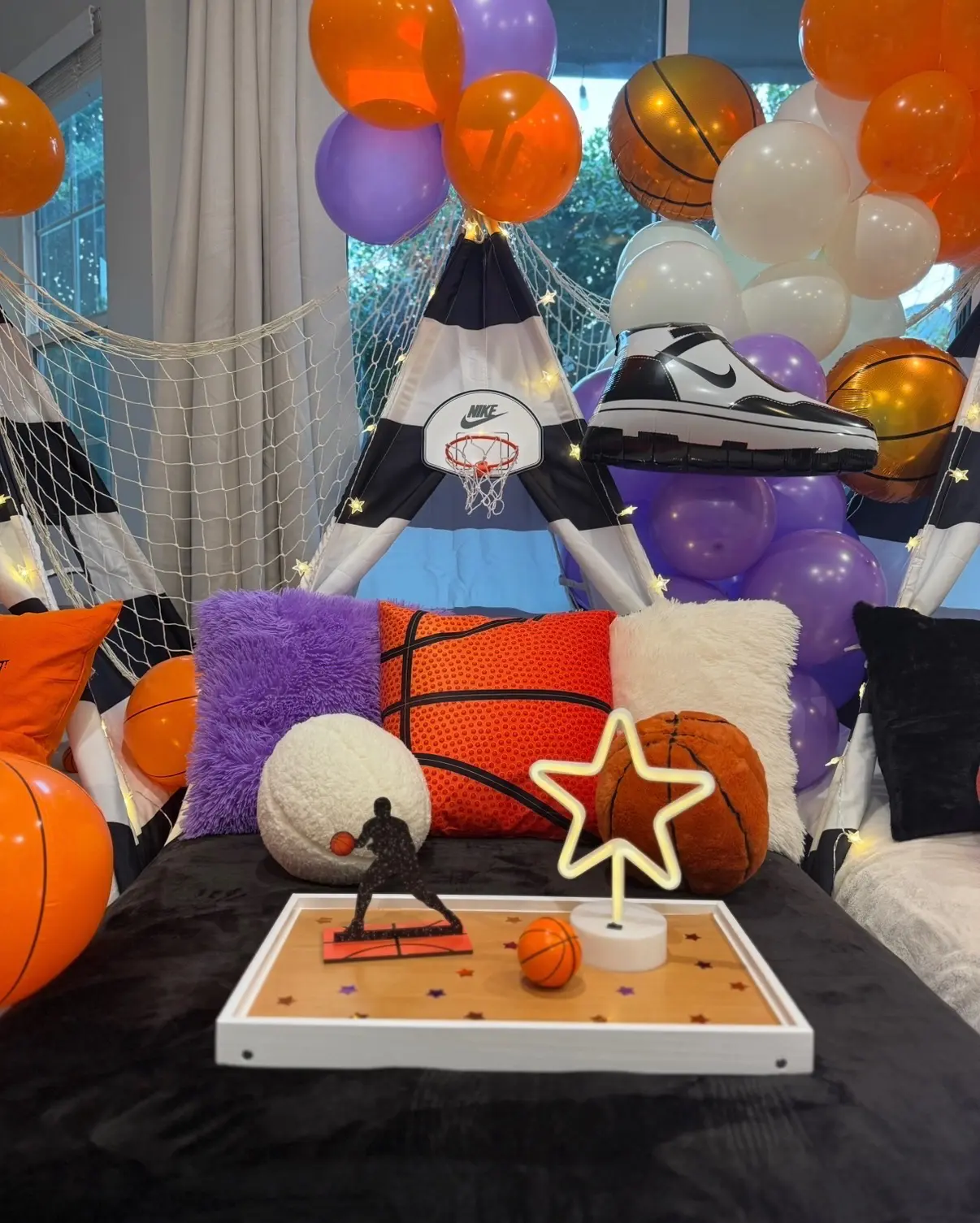 Basketball-themed teepee party with balloons and sneaker