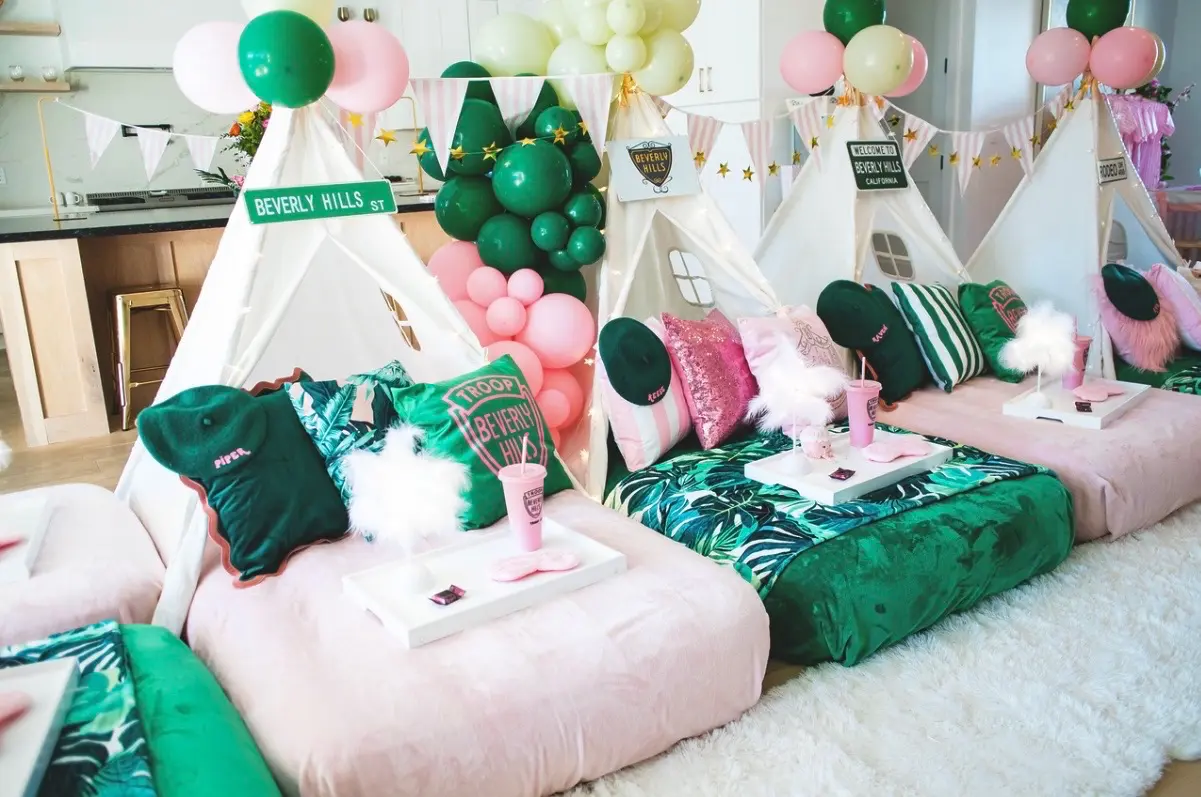 Pink and green teepee sleepover party setup