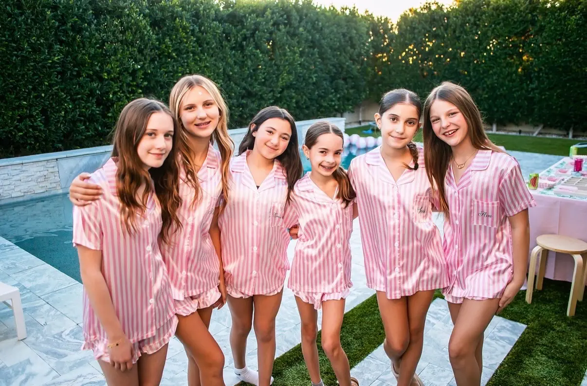 Six girls in pink striped pajama shirts