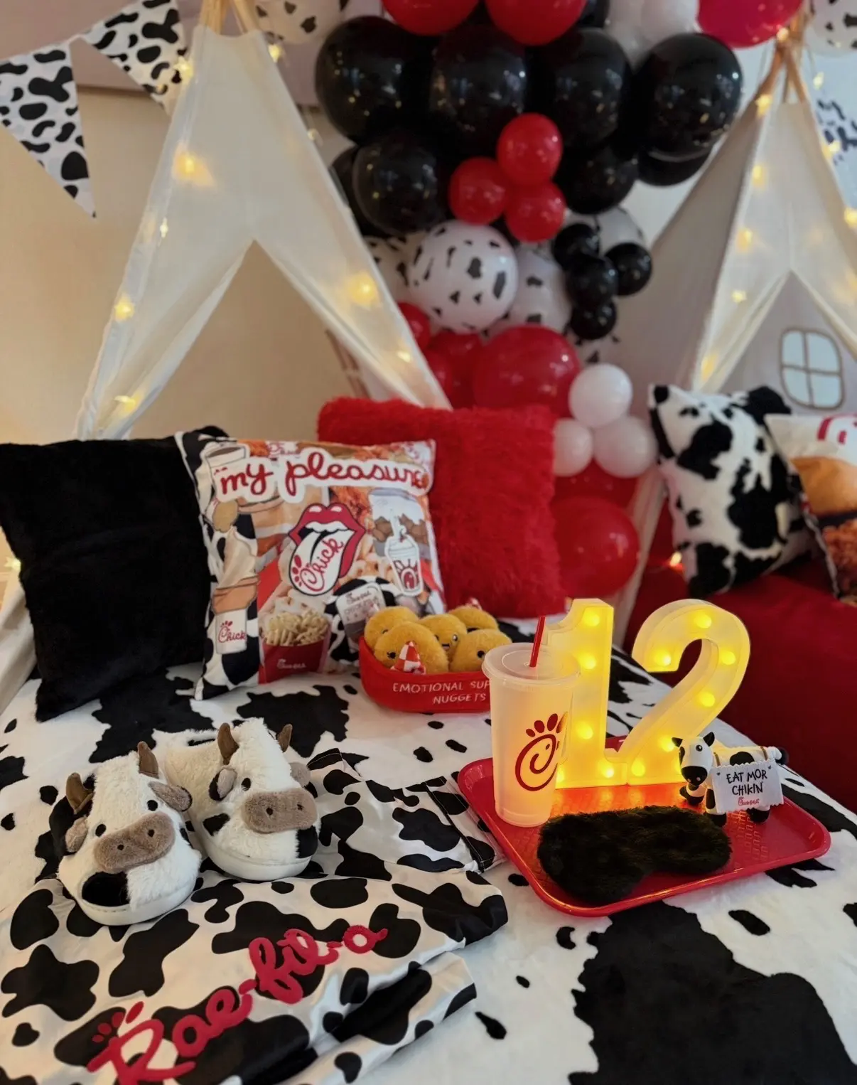 Cow-print sleepover tent with balloons