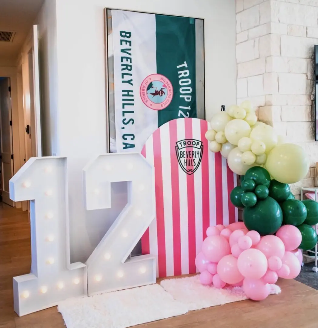Decorative setup with illuminated number 17, balloons, and a banner.