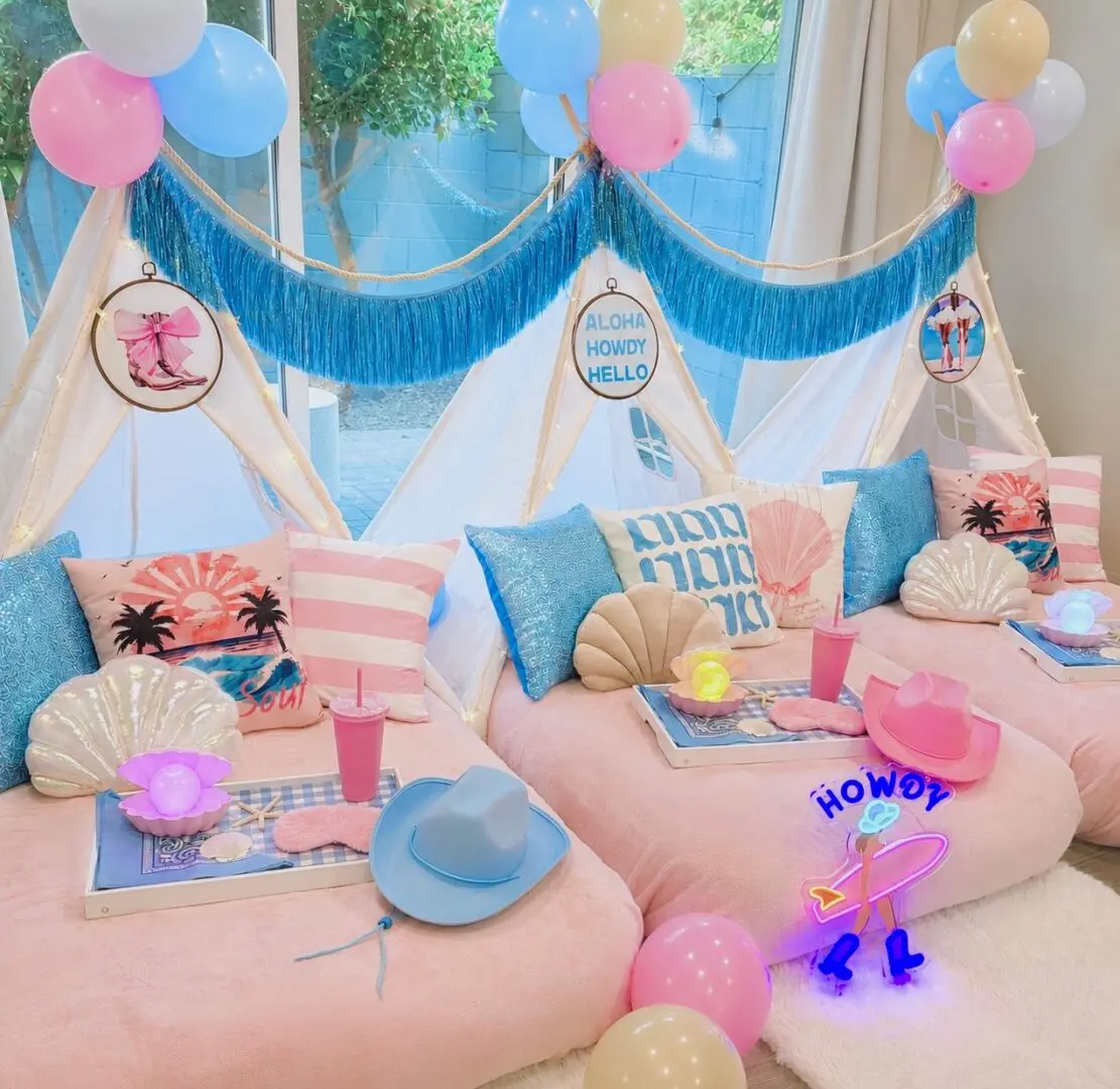 Pastel teepee sleepover setup with balloons