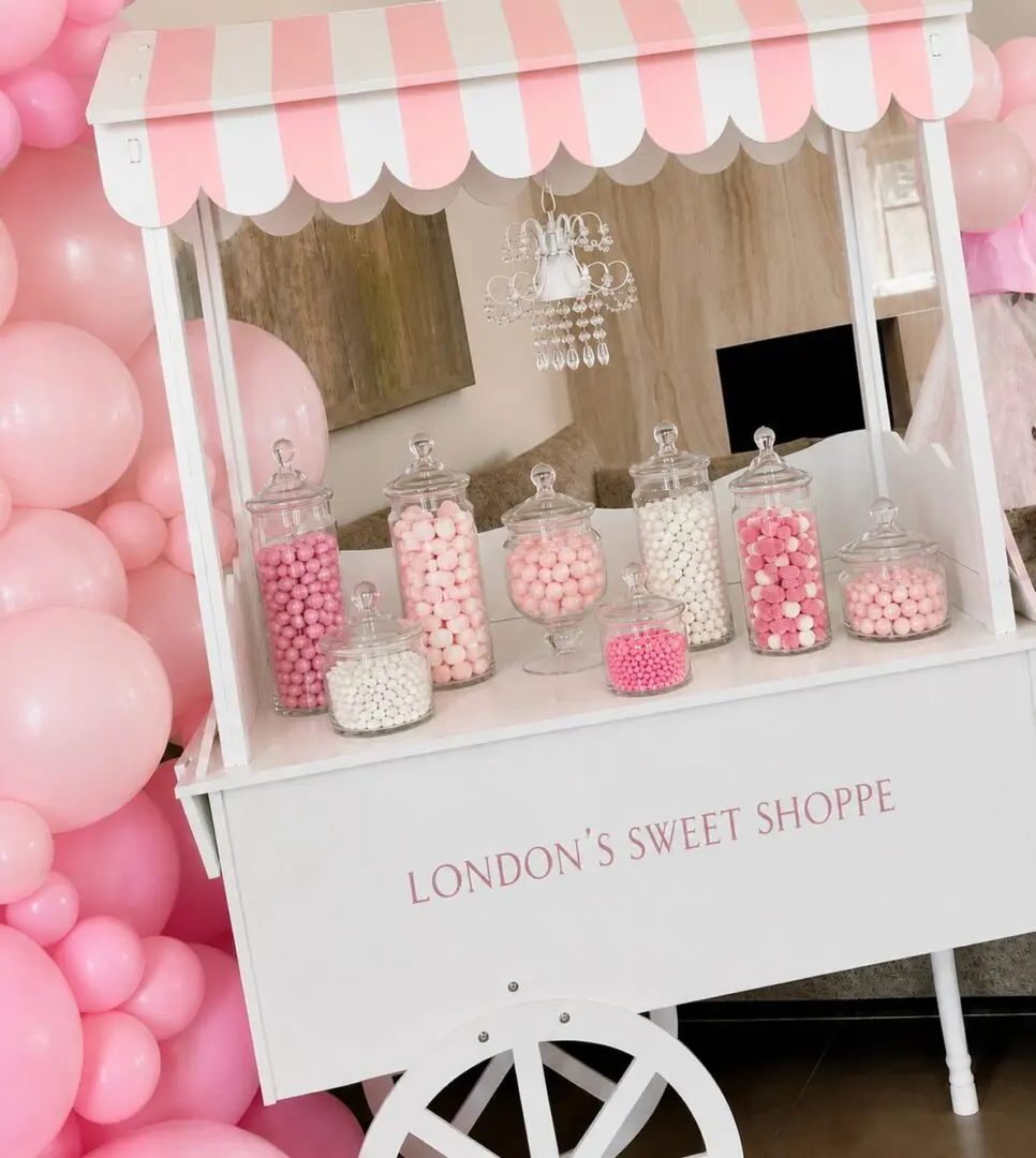 Pink and white candy cart with balloons