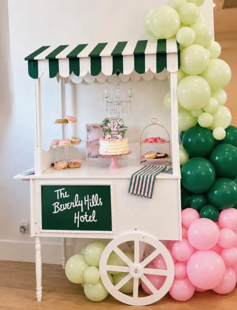 Dessert cart with cake and pastel balloons