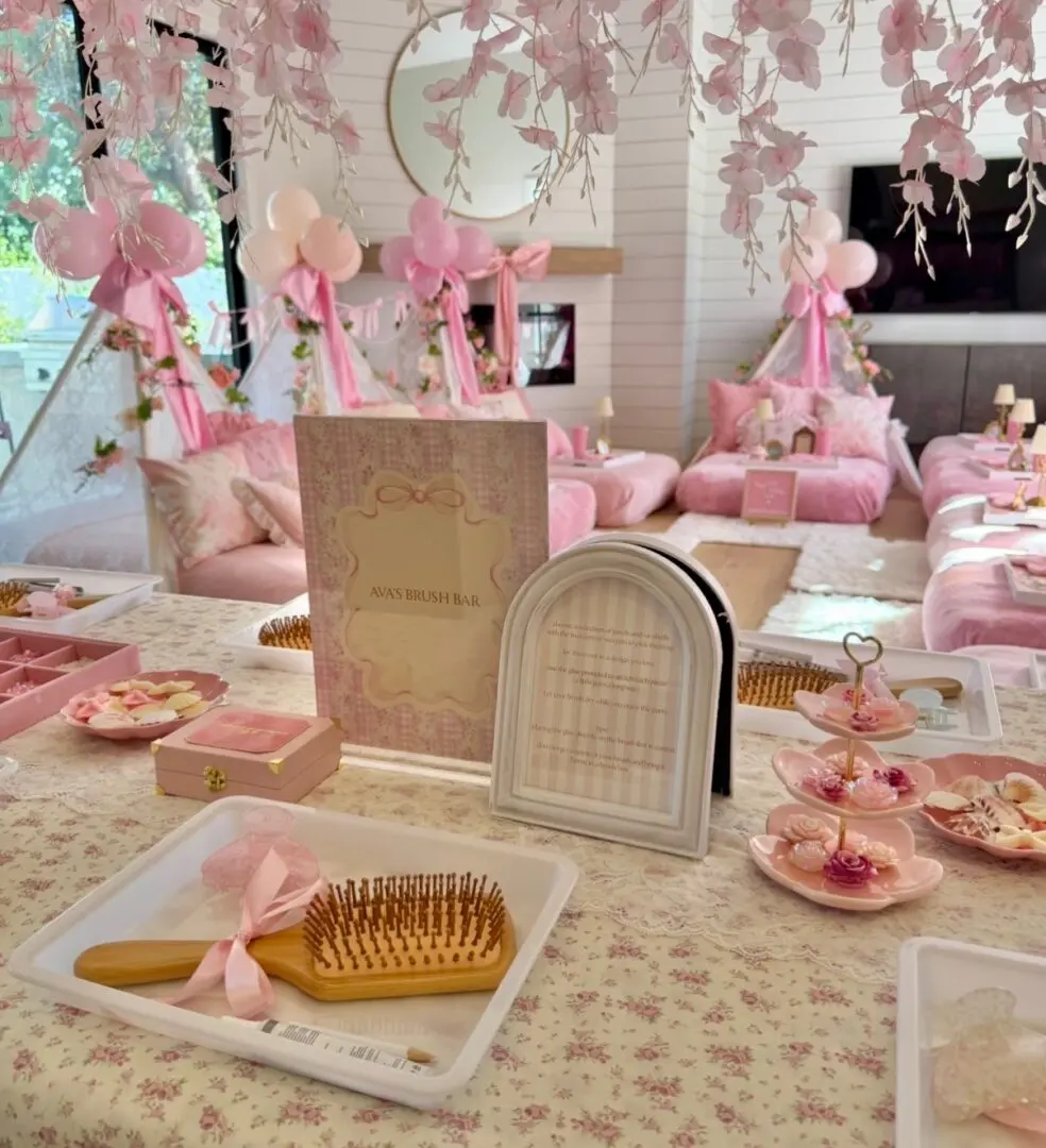 Pink spa party table with hairbrushes