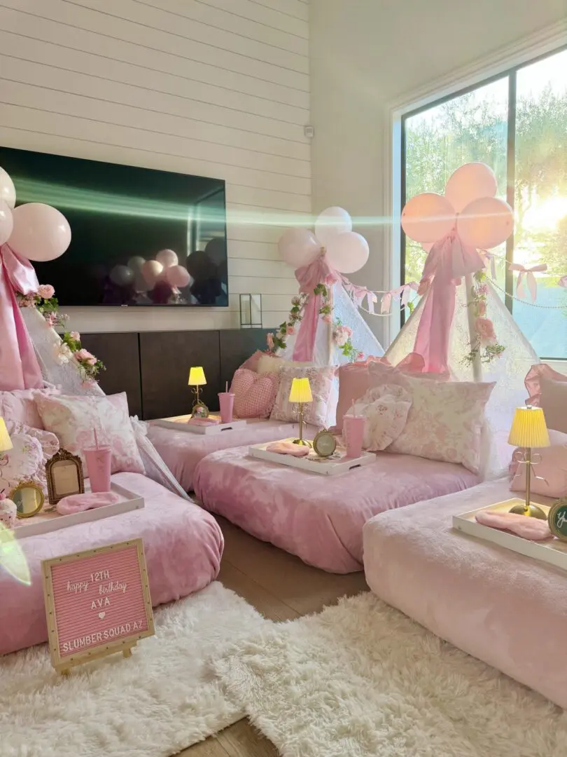 Pink indoor sleepover with tents and balloons