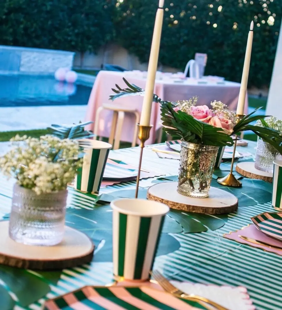Poolside pink and green tablescape with candles