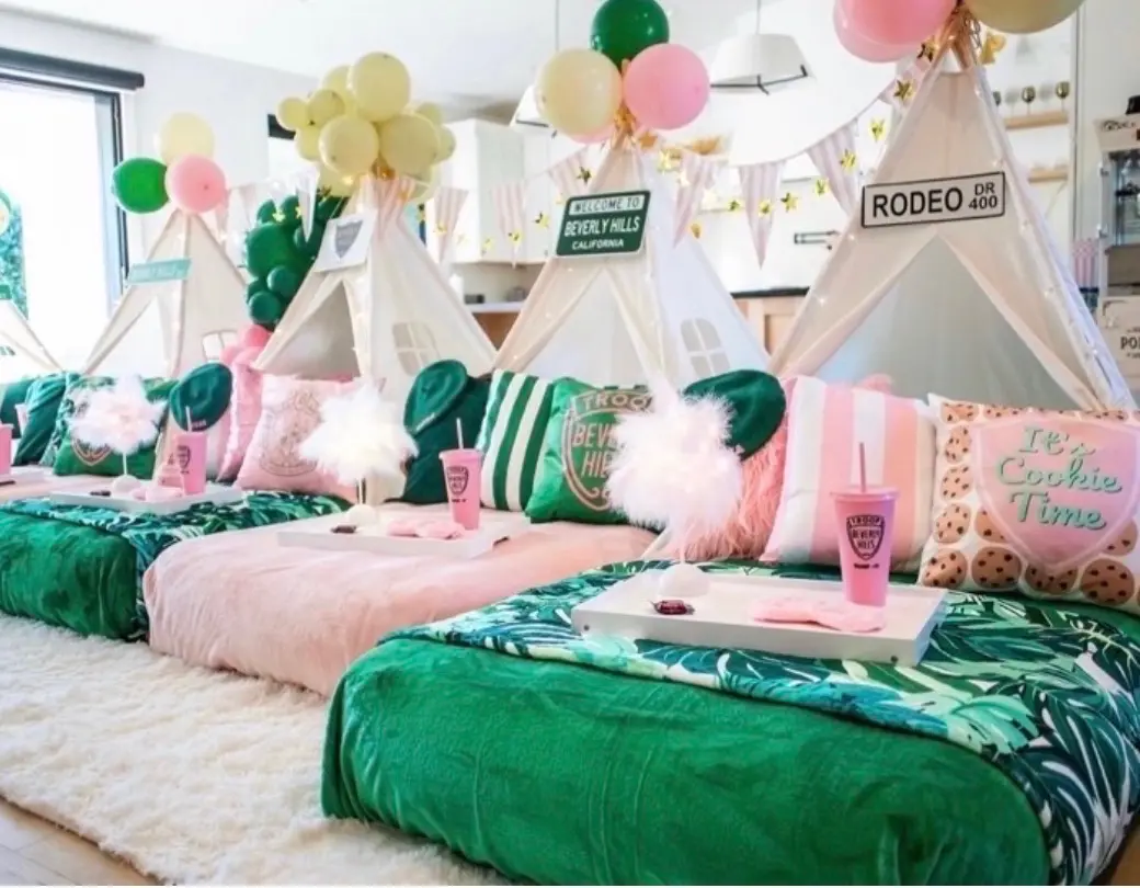 Pink and green teepee sleepover party setup