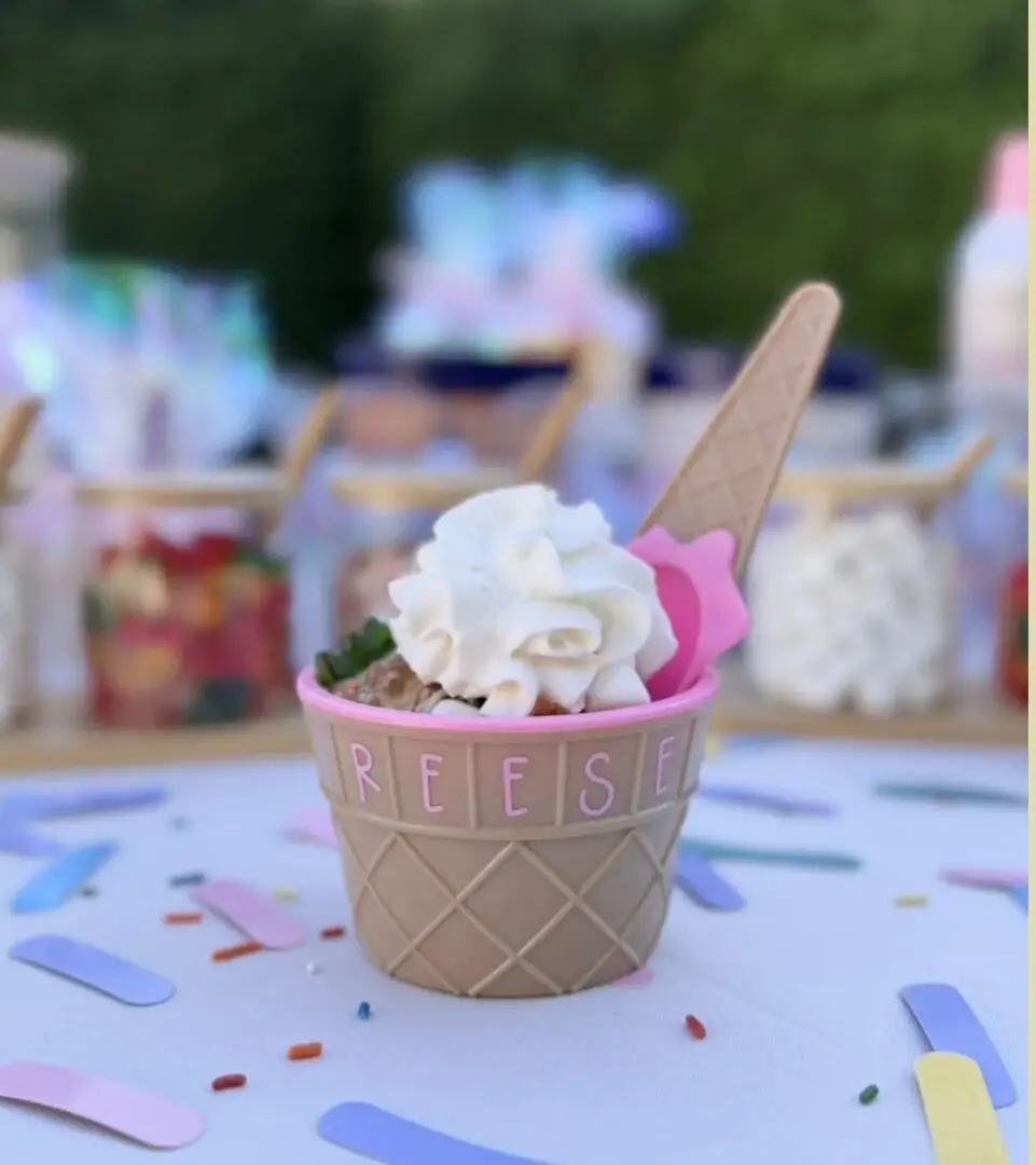 Mini ice cream cup topped with whipped cream