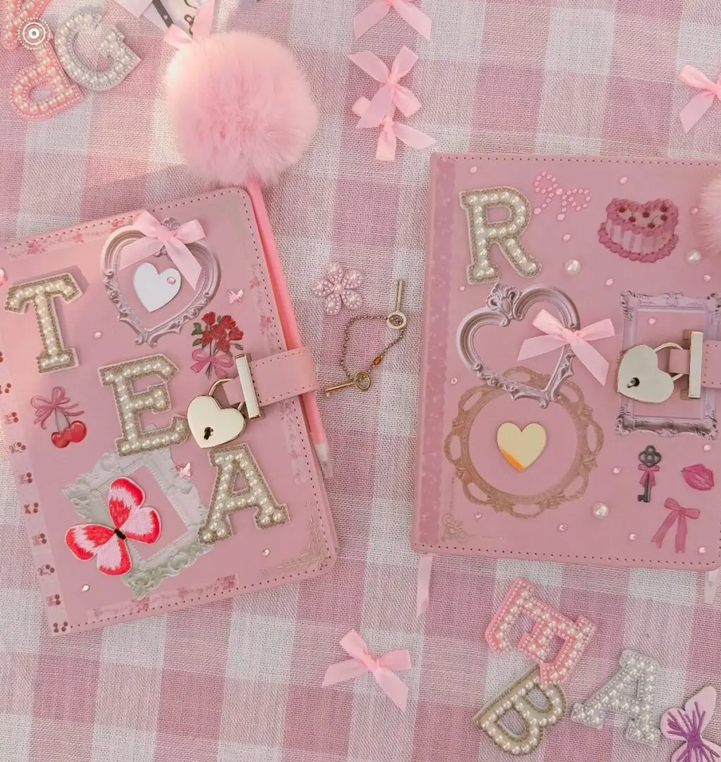 Two pink bejeweled journals on gingham fabric