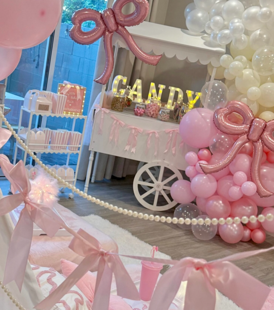 Pink candy cart party decorations with balloons