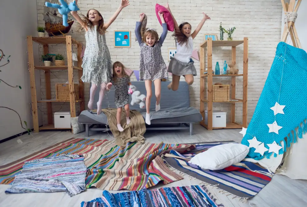 Children joyfully jumping on a sofa.