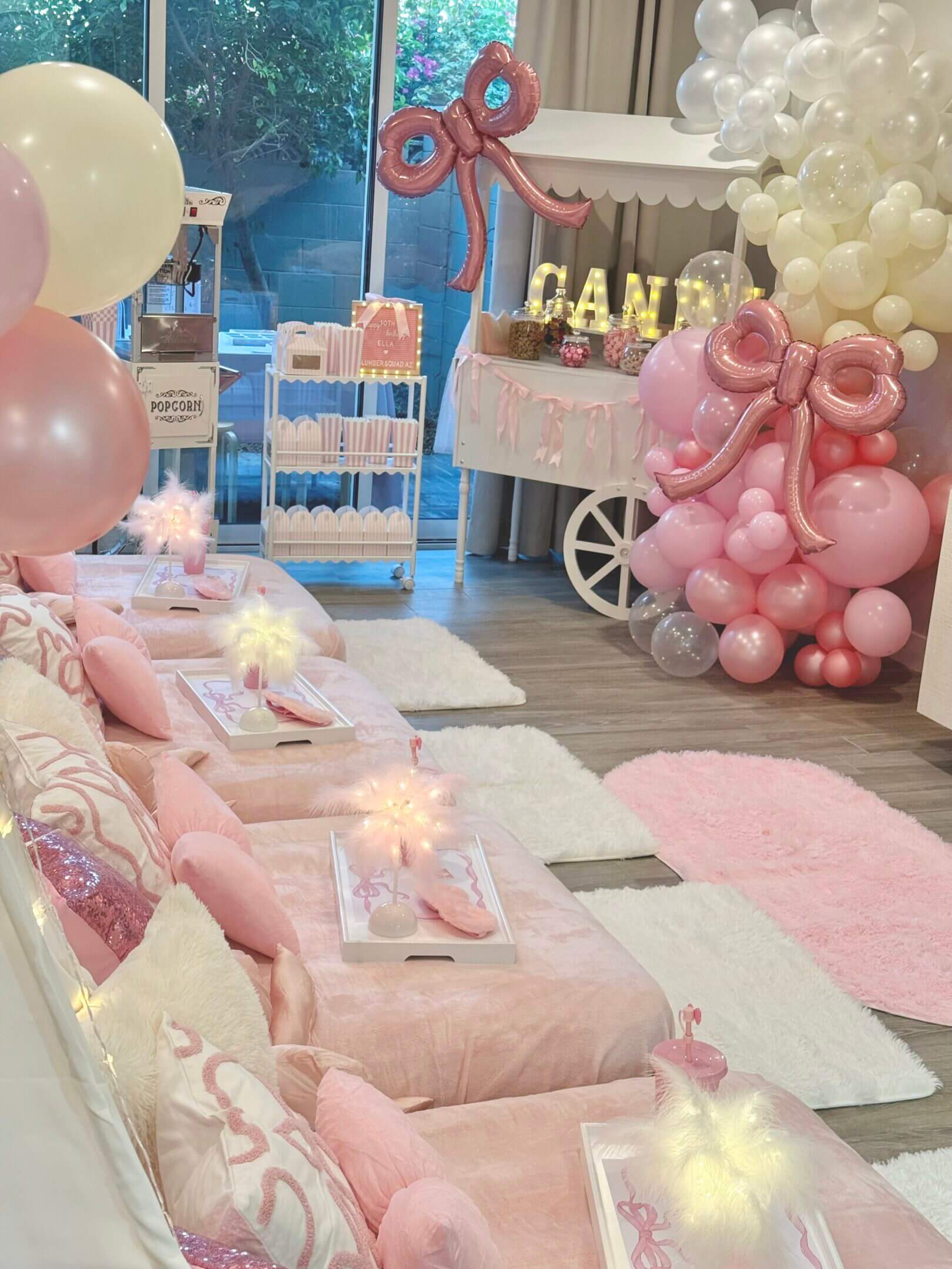 Pastel pink sleepover setup with balloon decorations