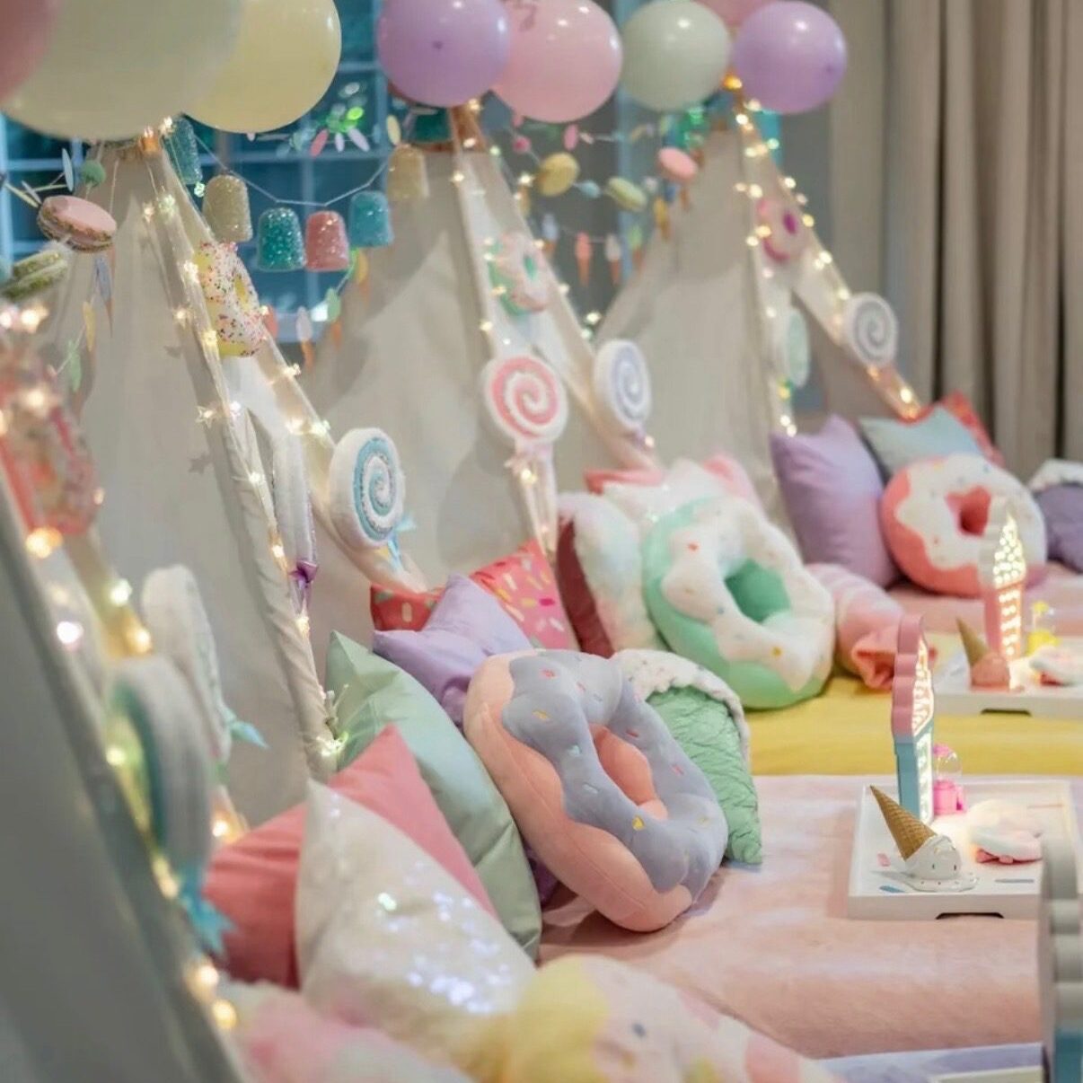 Pastel teepee sleepover with balloons and unicorns
